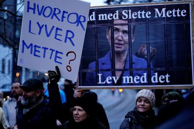 Placard-bearing protesters welcomed Denmark's Prime Minister Mette Frederiksen when she arrived to answer questions at a commission hearing. Reuters.