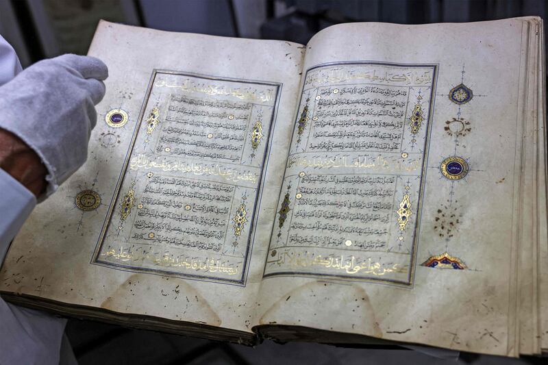 Librarian Khader Salameh restores a gilded copy of the Quran that dates back to the 16th century