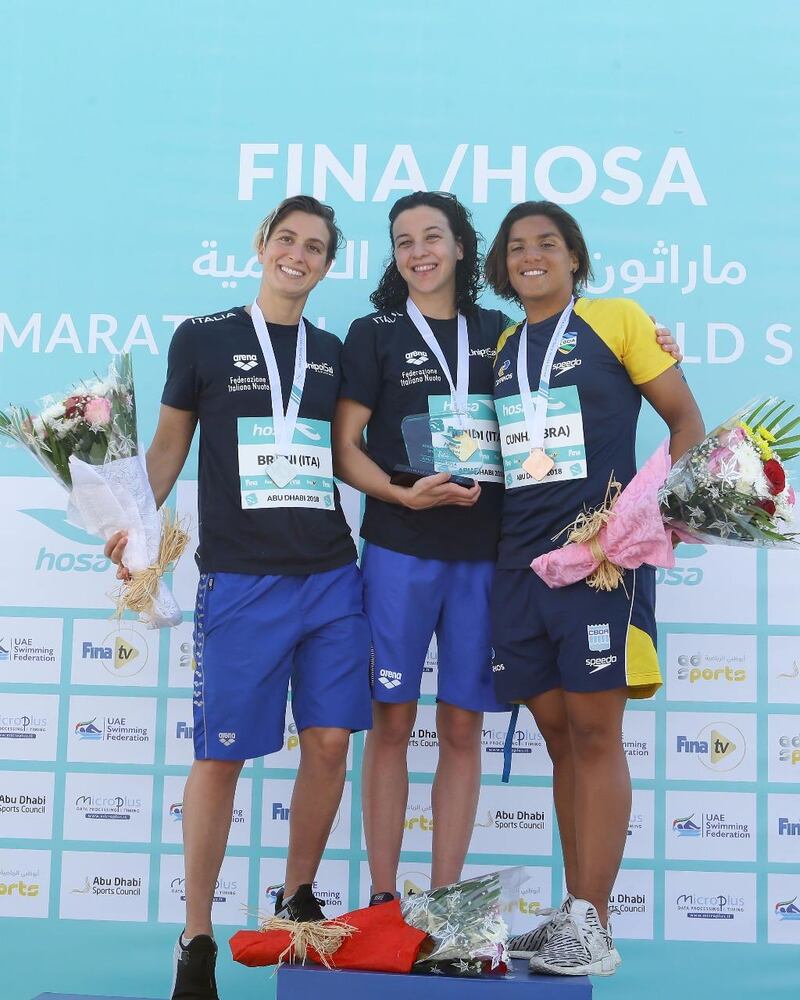 Adrianna Bridi celebrates her success in Abu Dhabi with Rachele Bruni, left, and Ana Marcela Cunha, right. Image courtesy of Abu Dhabi Sports Council 