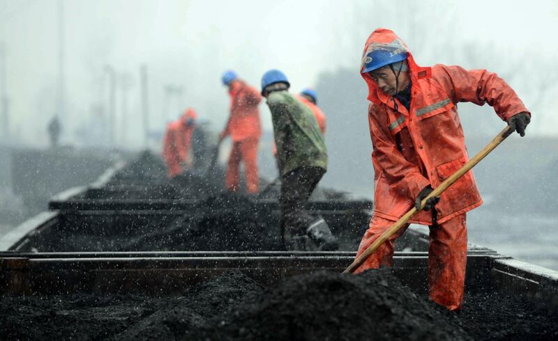 JIUJIANG, CHINA - JANUARY 22:  (CHINA OUT) Workers load coal onto railcars during a snowfall at a railway station on January 22, 2016 in Jiujiang, China. The National Meteorological Center (NMC) on Friday issued a yellow alert for blizzards that are expected to sweep China's northern, central and eastern regions.  (Photo by VCG/VCG via Getty Images)
