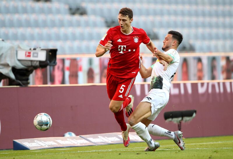 Benjamin Pavard of Bayern Munich is challenged by Ramy Bensebaini of Borussia Monchengladbach. EPA