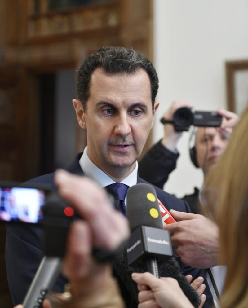 Syrian President Bashar Assad speaks with French journalists in Damascus. (SANA via AP))