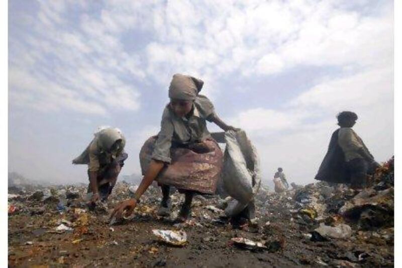 Rag pickers collect scraps from a dump on the outskirts of Hyderabad, southern India.