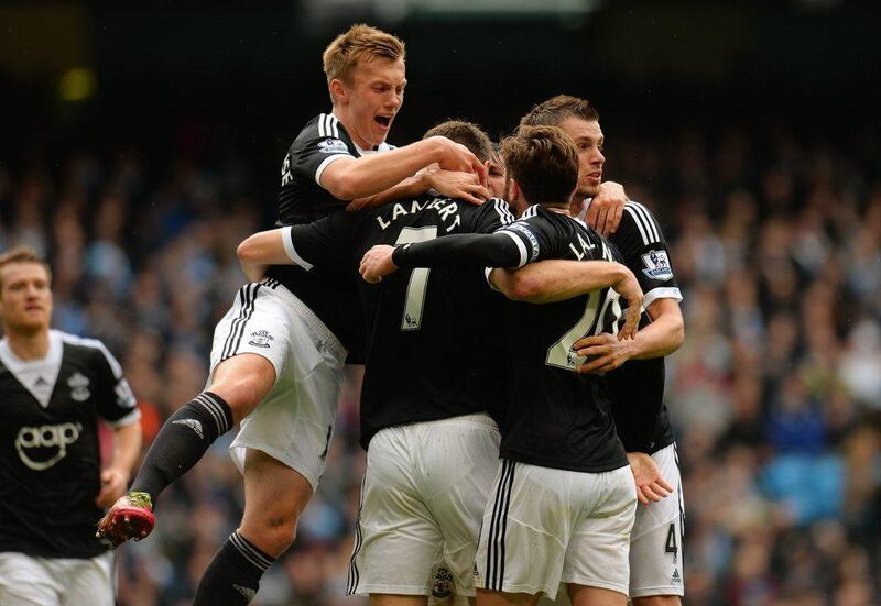 Rickie Lambert of Southampton is congratulated by teammates after scoring a goal from the penalty spot to level the scores at 1-1 during the Premier League match against Manchester City on Saturday. Shuan Botterill / Getty Images / April 5, 2014