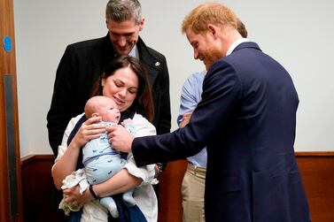 Britain's Prince Harry, Duke of Sussex, meets baby James Chalmers, aged five weeks and his mother Kornelia at Queen Elizabeth Hospital in Birmingham / Getty Images / POOL / Christopher Furlong