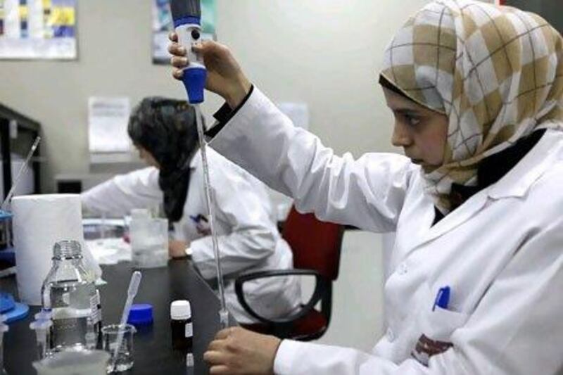 Specialists work at the labs of Amman Pharmaceuticals in Sahab. Salah Malkawi for The National