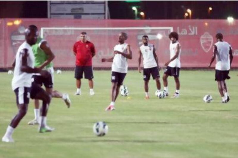 New Al Ahli coach Cosmin Olaroiu, in red, watches as he gets acquainted with his team during the first training session. The Romanian says now is the time he must understand how his players ‘play and how they train ... I have to change some things but not totally’.