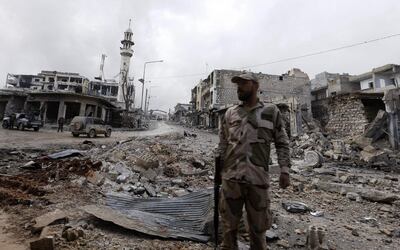 A picture taken during a guided tour organised by the Syrian ministry of information, shows a pro-regime fighter standing in the midst of rubble and buildings damaged by deadly regime and Russian air strikes, in the town of Maaret al-Numan, in the northwestern Idlib province, on January 30, 2020. Syrian government forces recaptured the strategic northwestern highway town of Maaret al-Numan from jihadist and allied rebels on January 28, in the latest blow to the country's last major opposition bastion.
 / AFP / LOUAI BESHARA
