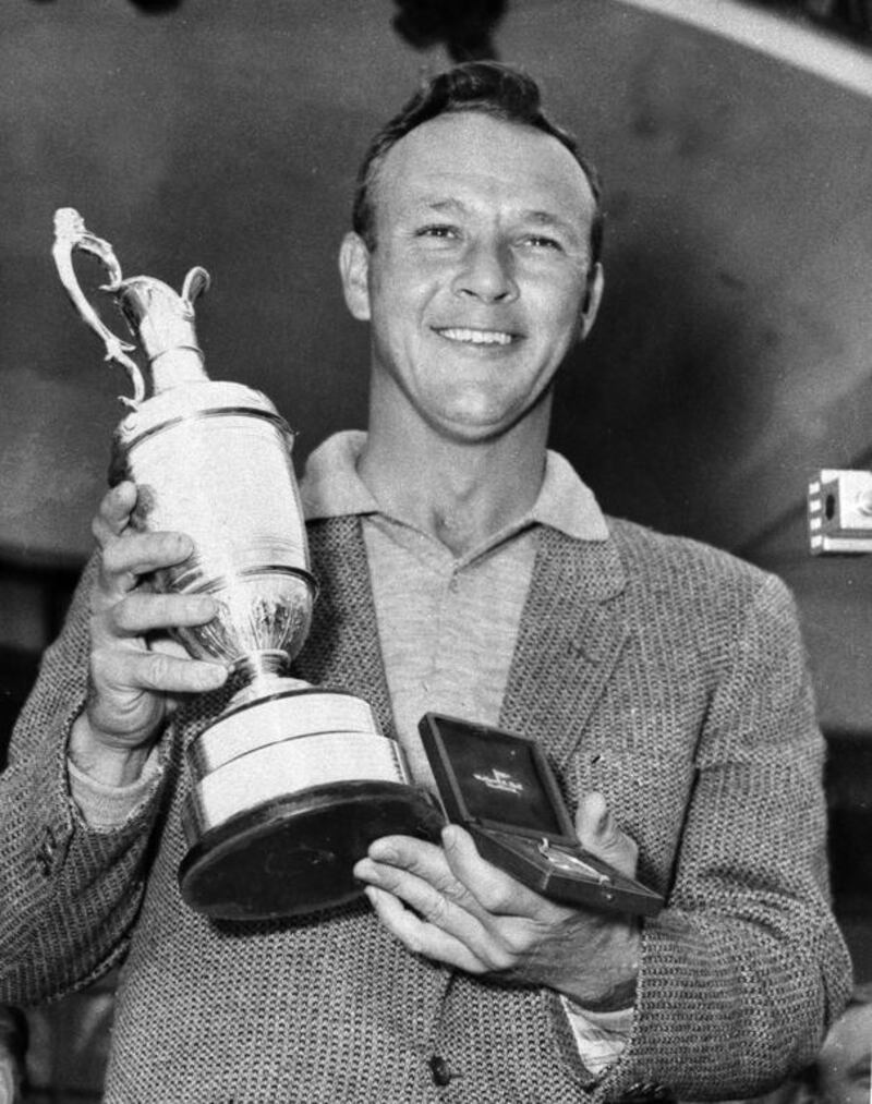 This July 15, 1961, file photo shows Arnold Palmer smiling with his trophy and medal after winning the British Open Golf Championship by a single stroke at Royal Birkdale course in Birkdale, Lancashire, England. AP Photo
