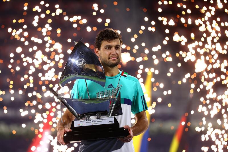 DUBAI, UNITED ARAB EMIRATES - MARCH 20:  Aslan Karatsev of Russia poses with the trophy after beating Lloyd Harris of South Africa to win the men's singles Final match during day fourteen of the Dubai Duty Free Tennis at Dubai Duty Free Tennis Stadium on March 20, 2021 in Dubai, United Arab Emirates. (Photo by Francois Nel/Getty Images)