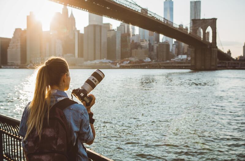 Woman photographer taking picture of Lower Manhattan