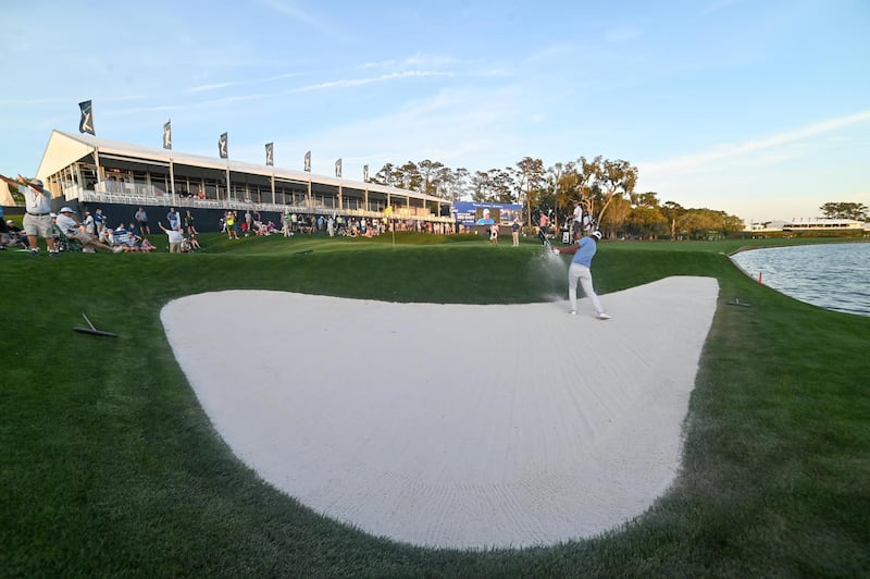 Tony Finau hits out of the sand at the 18th. USA Today
