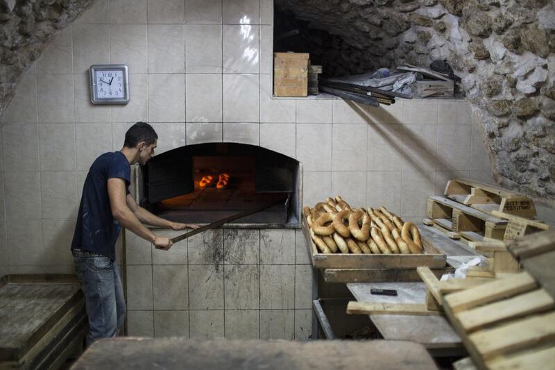 A Palestinian man, Makes Ka’aek at his bakery  in the Old City of Jerusalem, during Ramadan.