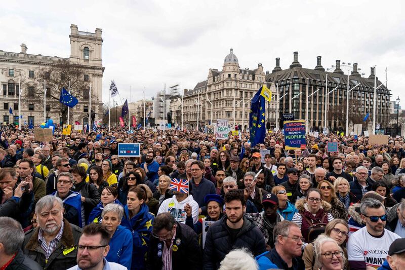 Crowds gather after the march to listen to speakers at a rally organised by the pro-European People's Vote campaign for a second EU referendum in Parliament Square, central London on March 23, 2019.  AFP