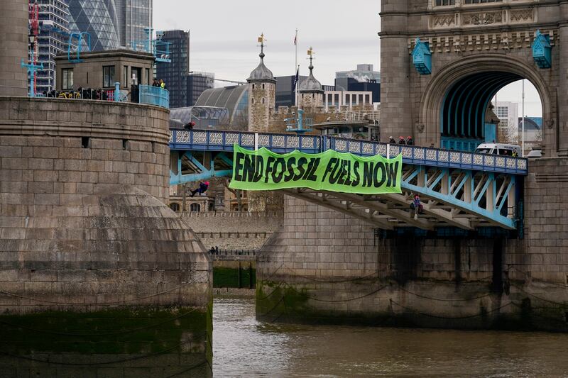 A banner hung from Tower Bridge in London by Extinction Rebellion. AP
