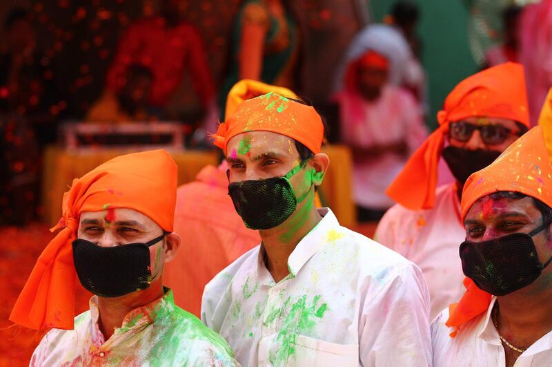 People wearing facemasks celebrate Holi, the spring festival of colours, during an event organised by Trishla Foundation, a non-profit organisation for cerebral palsy treatment, in Allahabad on March 6, 2020. AFP