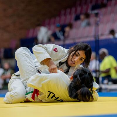 Shamma Al Kalbani, top, on her way to victory over Orapa Senatham of Thailand. Photo: UAEJJF