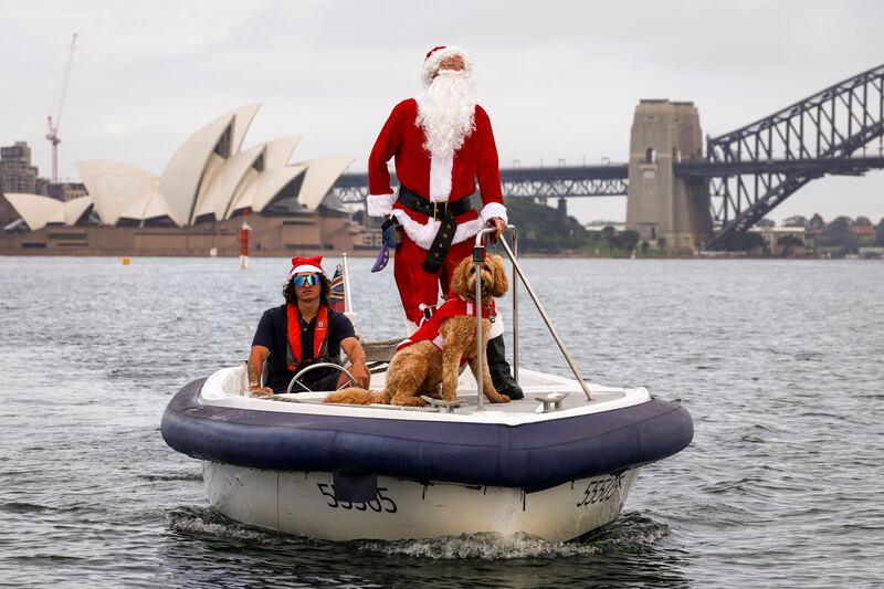 A man dressed as Santa Claus in front of the Sydney Opera House, as part of Christmas Day celebrations for the annual Sydney to Hobart yacht race. AFP