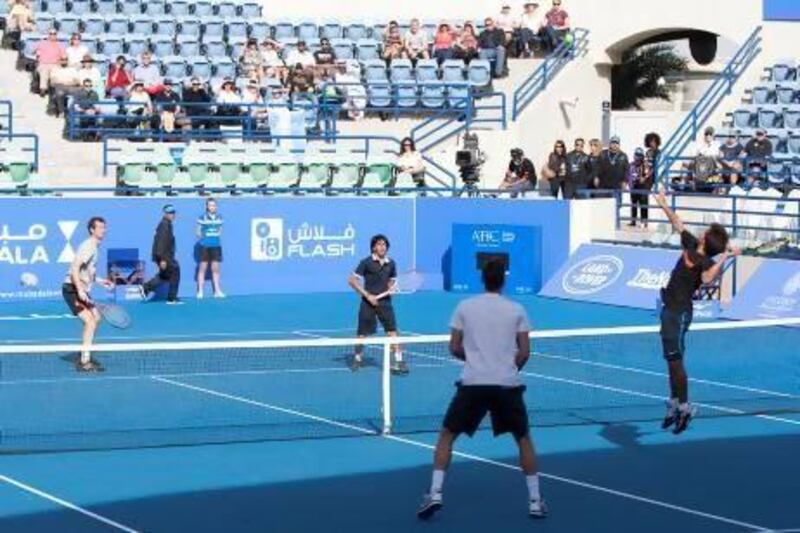 From left, Andy Murray teamed up with Abdulrahman Al Janahi against Tomas Berdych and Hamad Janahi in an exhibition match. Mike Young / The National