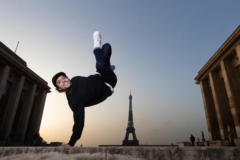 French street dancer Bboy Mounir performs in front of the Eiffel Tower in Paris. AFP