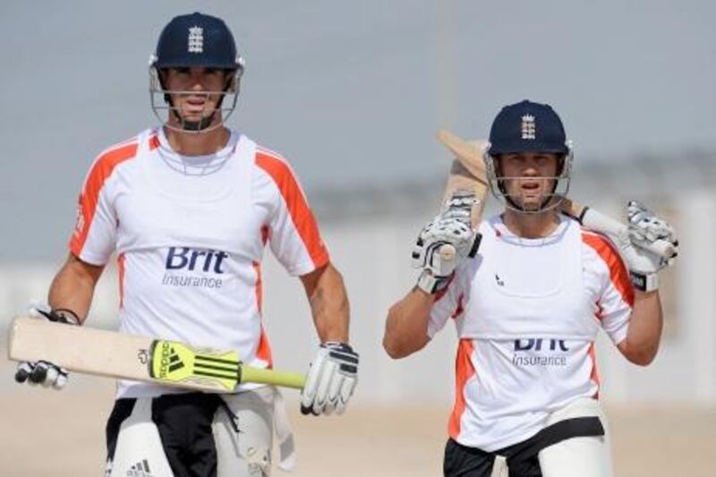 England's cricketers Jonathan Trott (R) and Kevin Pietersen walk towards a batting net during a practice session at the Sheikh Zayed Stadium in Abu Dhabi on January 23, 2012. AFP PHOTO/Lakruwan WANNIARACHCHI
 *** Local Caption ***  704075-01-08.jpg