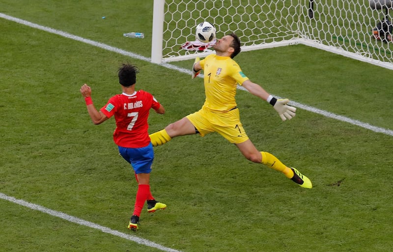 Costa Rica's Christian Bolanos, left, tries to score as Serbia goalkeeper Vladimir Stojkovic makes a save. Vadim Ghirda / AP Photo