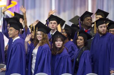 NYUAD students wave to friends and family during the graduation ceremony. Christopher Pike / The National
