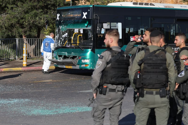 Israeli security forces gather at the scene of an explosion at a bus stop in Jerusalem. AFP