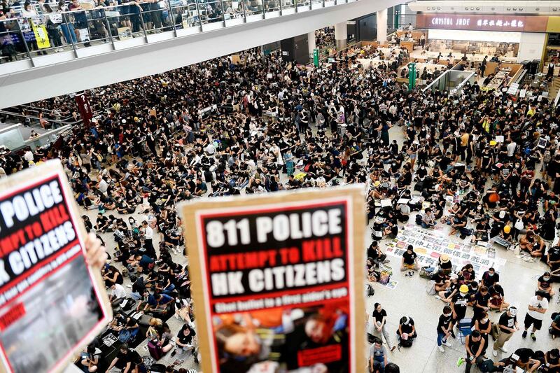 Pro-democracy protesters gather against the police brutality and the controversial extradition bill at Hong Kong's international airport.  AFP