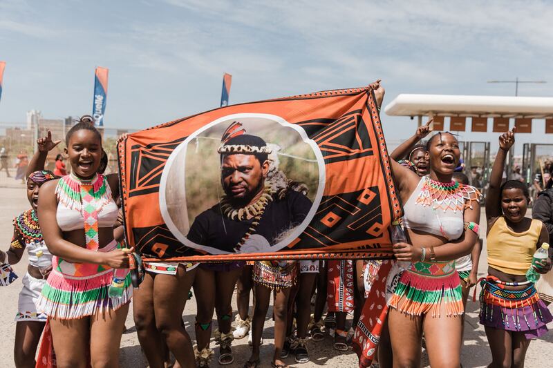 Young girls carry a banner of King Misuzulu at the coronation at the Moses Mabhida Stadium in Durban. AFP