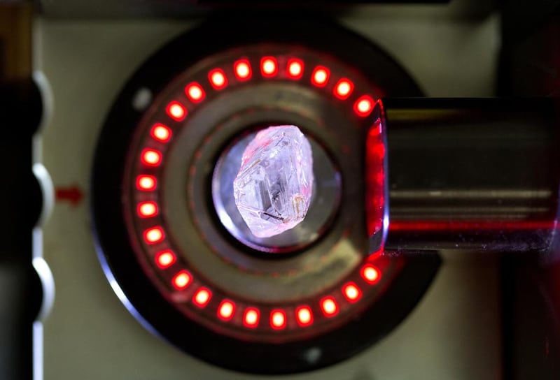 An unpolished natural diamond is scanned by a laser machine before being cut into two segments. Andrey Rudakov / Bloomberg