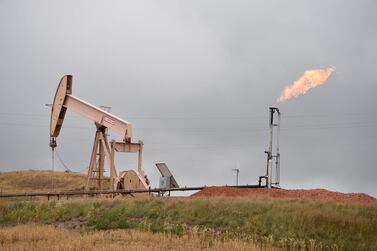 Pump jacks and a gas flare near Williston, North Dakota. US shale’s abundant production is a counterbalance to Opec’s supply cuts.. AFP