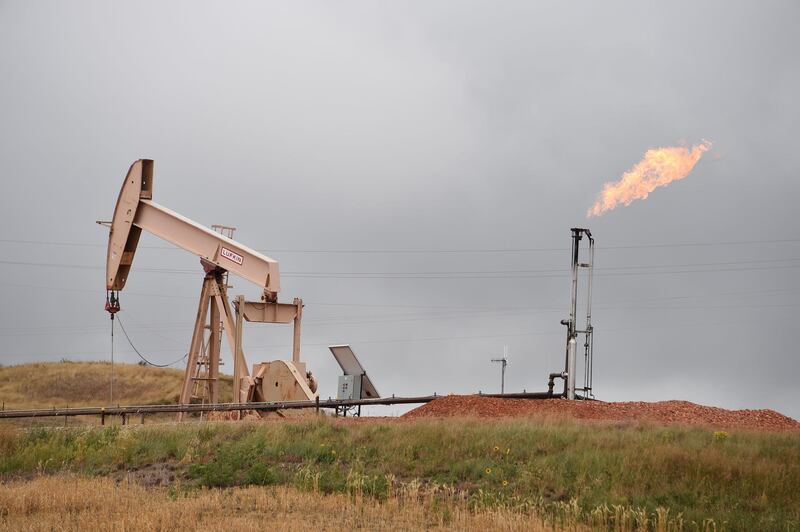 (FILES) In this file photo taken on September 6, 2016 shows pump jacks and a gas flare  near Williston, North Dakota. Oil prices gained November 29, 2018 after the US benchmark slid below $50 a barrel following reports Russia could join a production cut at next month's OPEC meeting. The gains in petroleum prices came on a mixed day for global stocks as traders worldwide weighed Federal Reserve comments that were widely seen as dovish on monetary policy.

 / AFP / Robyn BECK
