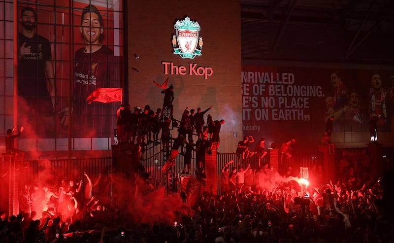 Fans celebrate at Anfield after Liverpool were crowned Premier League champions without kicking a ball on Thursday as Chelsea's 2-1 win over Manchester City ended the Reds' 30-year wait to win the English title. AFP