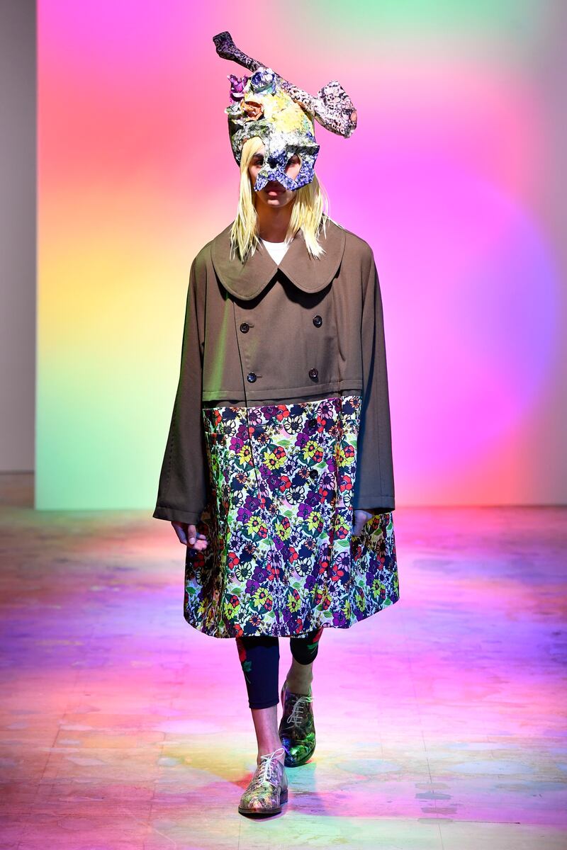 An oversized pea coat becomes a hybrid with pink and yellow daisy fabric at Comme des Garcons for spring / summer 2022. Courtesy Comme des Garcons