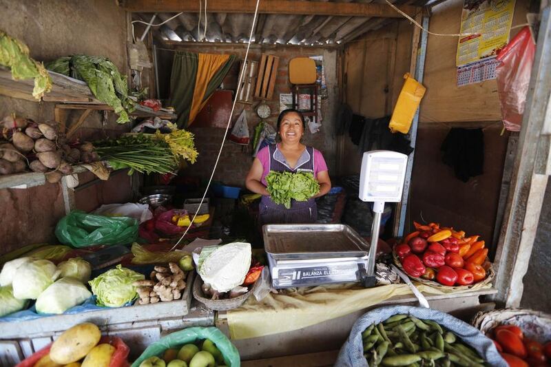 Teodora Martinez poses in her grocery shop in Gosen City. Martinez was one of the original founders of the market after emigrating from the highland city of Huancayo. Mariana Bazo / Reuters