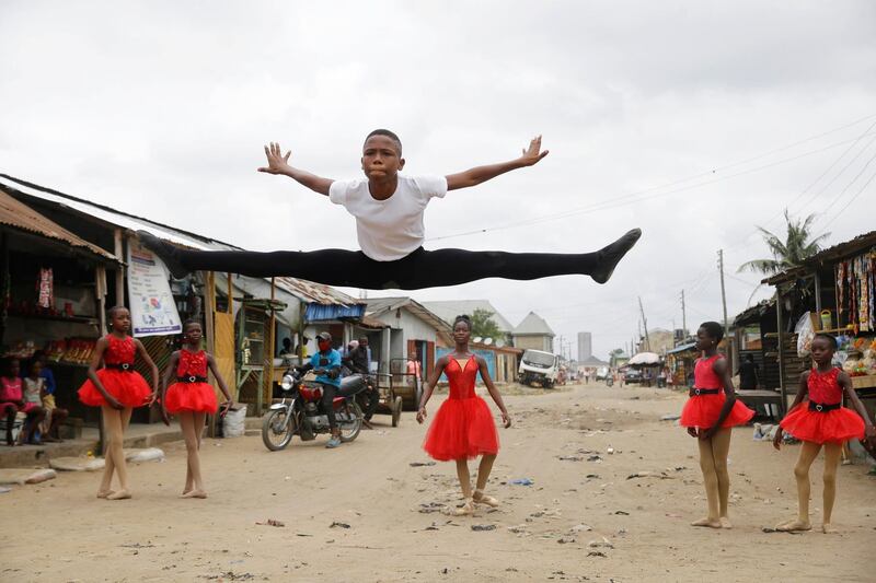 Ballet student Anthony Mmesoma Madu, centre, dances in the street as fellow dancers look on in Lagos, Nigeria. AP photo