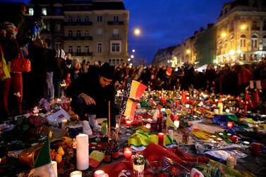 Mourners gather at a makeshift memorial on the Place de la Bourse (Beursplein) in Brussels, a day after a triple bomb attack in March 2016. AFP