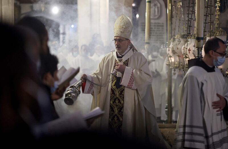 Latin Patriarch of Jerusalem Pierbattista Pizzaballa burns incense around the Stone of Anointing during an Easter vigil mass on Holy Saturday at the Church of the Holy Sepulchre, Jerusalem. AFP