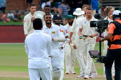 Sri Lanka's Oshada Fernando (2nd L) walks back to the pavilion after victory in the second Test cricket match between South Africa and Sri Lanka at St. George's Park Stadium in Port Elizabeth on February 23, 2019.  / AFP / RODGER BOSCH
