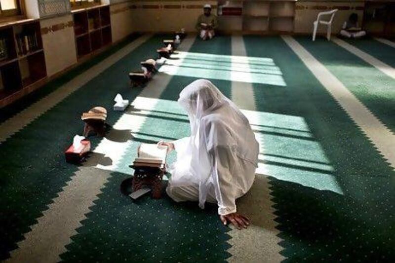 A man reads the Quran during afternoon prayers at a mosque in Abu Dhabi in the Holy Month of Ramadan. Silvia Razgova / The National