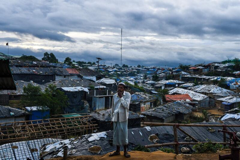 A Rohingya refugee man stands before Kutupalong camp in Ukhia near Cox's Bazar on August 13, 2018. - Nearly 700,000 Rohingya fled Myanmar's Rakhine state last year to escape a violent military crackdown. (Photo by CHANDAN KHANNA / AFP)