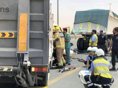 Civil Defence attempt to free the motorists trapped in the truck. Courtesy UAQ Civil Defence 