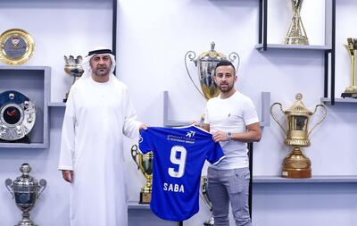 A handout picture provided by the Emirati club Al-Nasr SC on September 27, 2020, shows Israeli midfielder Dia Saba (R) posing with a club official during his official presentation at the club. - An Emirati club has for the first time signed an Israeli footballer, Diaa Sabia, less than two weeks after the UAE normalised ties with the Jewish state. Sabia, a 27-year-old Israeli Arab attacking midfielder with China's Guangzhou R&F, signed a two-year contract with Dubai's Al-Nasr, the club said in a statement Sunday. (Photo by - / Al-Nasr SC / AFP) / === RESTRICTED TO EDITORIAL USE - MANDATORY CREDIT "AFP PHOTO / HO / AL-NASR SC" - NO MARKETING NO ADVERTISING CAMPAIGNS - DISTRIBUTED AS A SERVICE TO CLIENTS ===