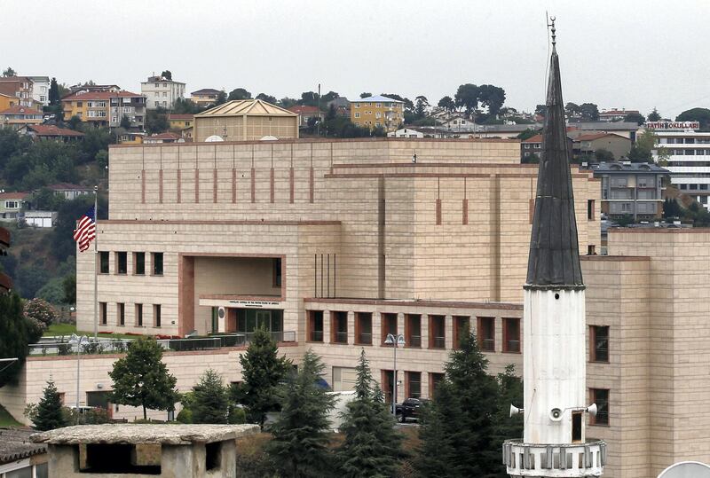 FILE - In this Tuesday, Aug. 11, 2015 file photo, a mosque's minaret is seen backdropped by the United States consulate building in Istanbul.  Metin Topuz, a translator and fixer for the Drug Enforcement Agency, working at the consulate, is set to go on trial in March on charges of espionage and attempting to overthrow the Turkish government, a court decided Friday, Feb. 1, 2019. Topuz, has been in custody since October 2017. (AP Photo/Emrah Gurel, FILE)