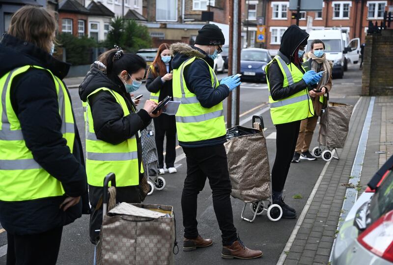 Officials gather to distribute coronavirus disease (COVID-19) swab tests to households after a new SARS-CoV-2 coronavirus variant originating from South Africa was discovered, in Ealing, west London, Britain February 4, 2021. REUTERS/Toby Melville