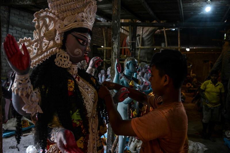 An artist gives the final touches to an idol of Kali, the Hindu goddess of power, in Siliguri, West Bengal. AFP