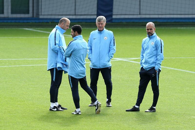 Josep Guardiola, manager of Manchester City, and his backroom staff look on during a training session. Getty Images