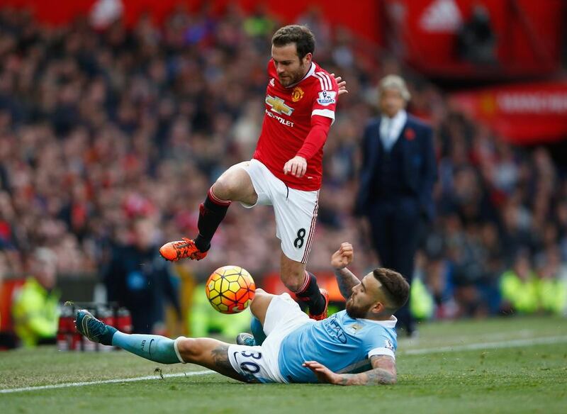 Juan Mata of Manchester United is tackled by Nicolas Otamendi of Manchester City during the Barclays Premier League match between Manchester United and Manchester City at Old Trafford on October 25, 2015 in Manchester, England. (Photo by Clive Rose/Getty Images)