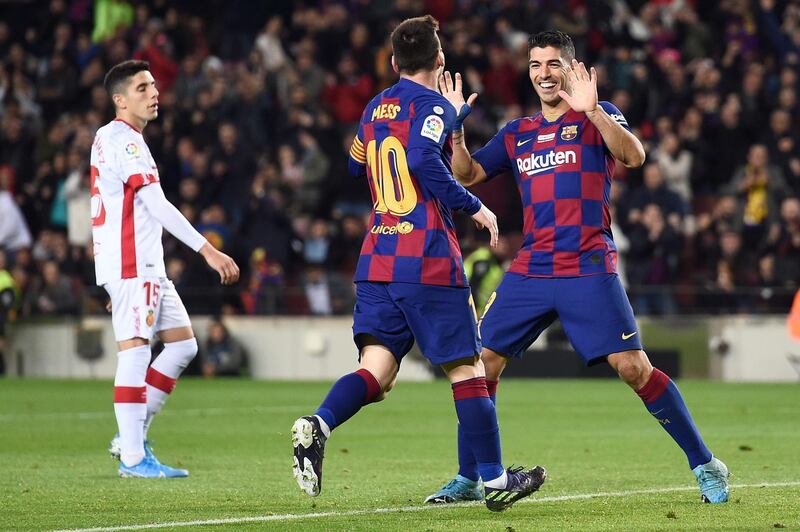 Messi celebrates his hat-trick with Luis Suarez. AFP